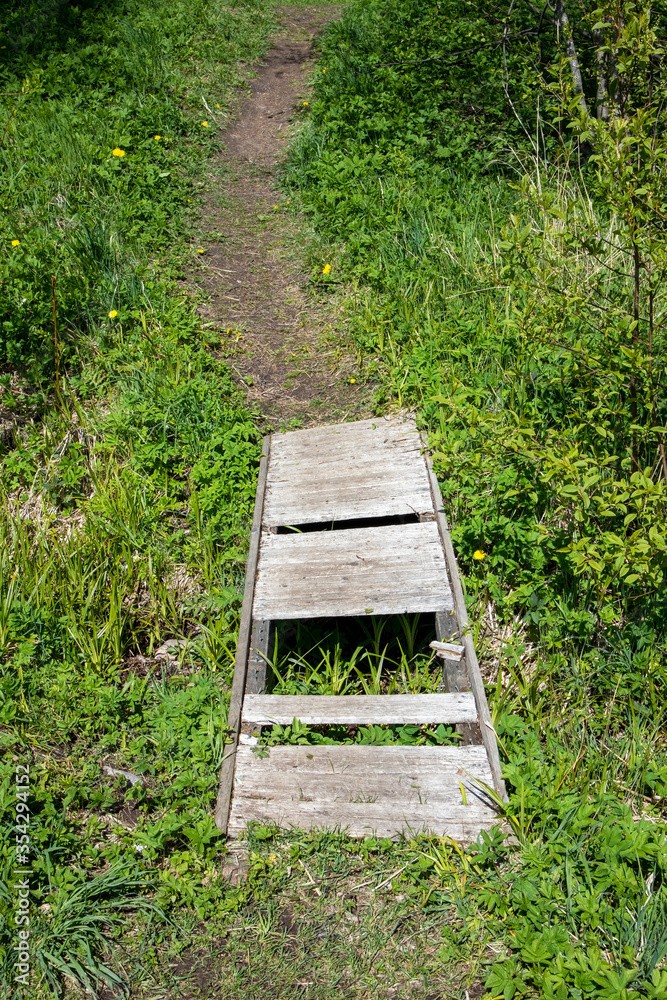 little wooden bridge with missing planks little wooden bridge with missing planks
