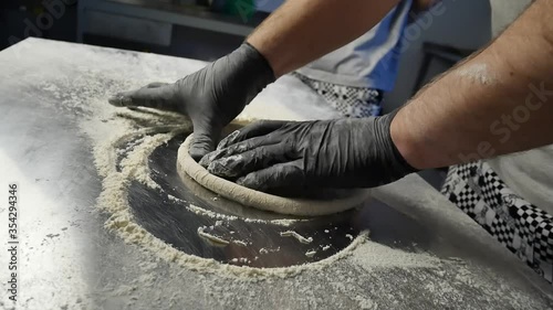 dynamic closeup of making pizza dough at italian restaurant