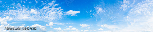 Panorama of a blue sky with white clouds as a backround
