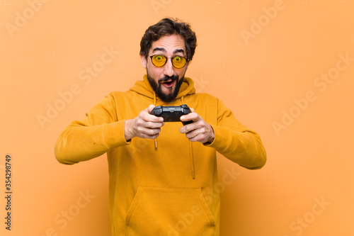 young crazy cool man paying with a game console controller