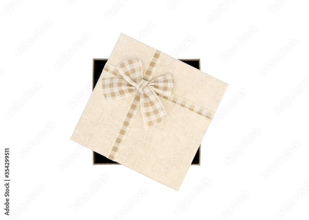 Beige coloured box with tartan ribbon shot against white background with copyspace/space for text Beige coloured box with tartan ribbon shot against white background with copyspace/space for text