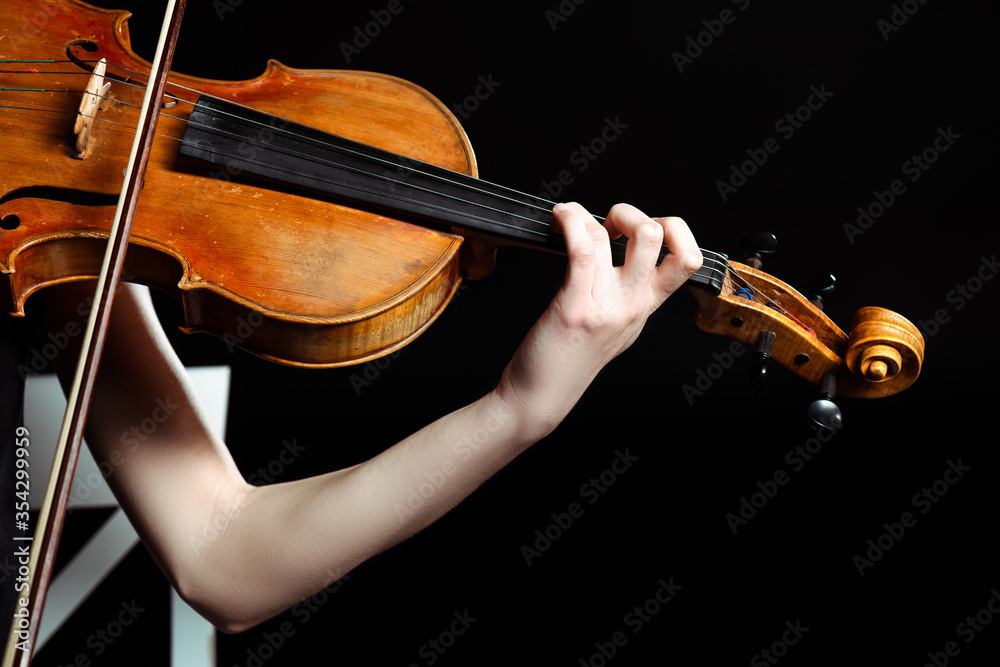 Fototapeta cropped view of female musician playing on violin isolated on black