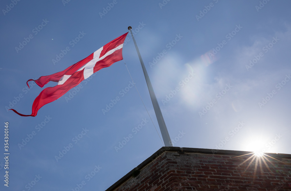 Danish flag with blue aky and a sun star