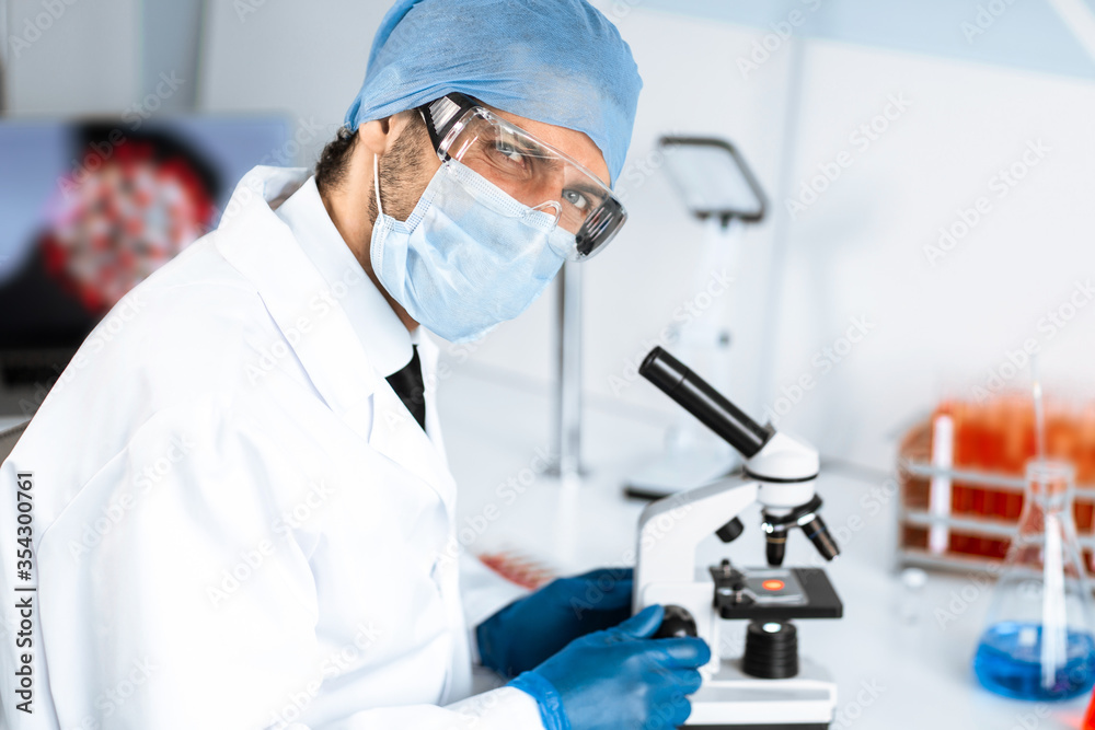 talented scientist sitting at a table in the laboratory. talented scientist sitting at a table in the laboratory.