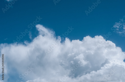 large white cloud against a blue summer sky