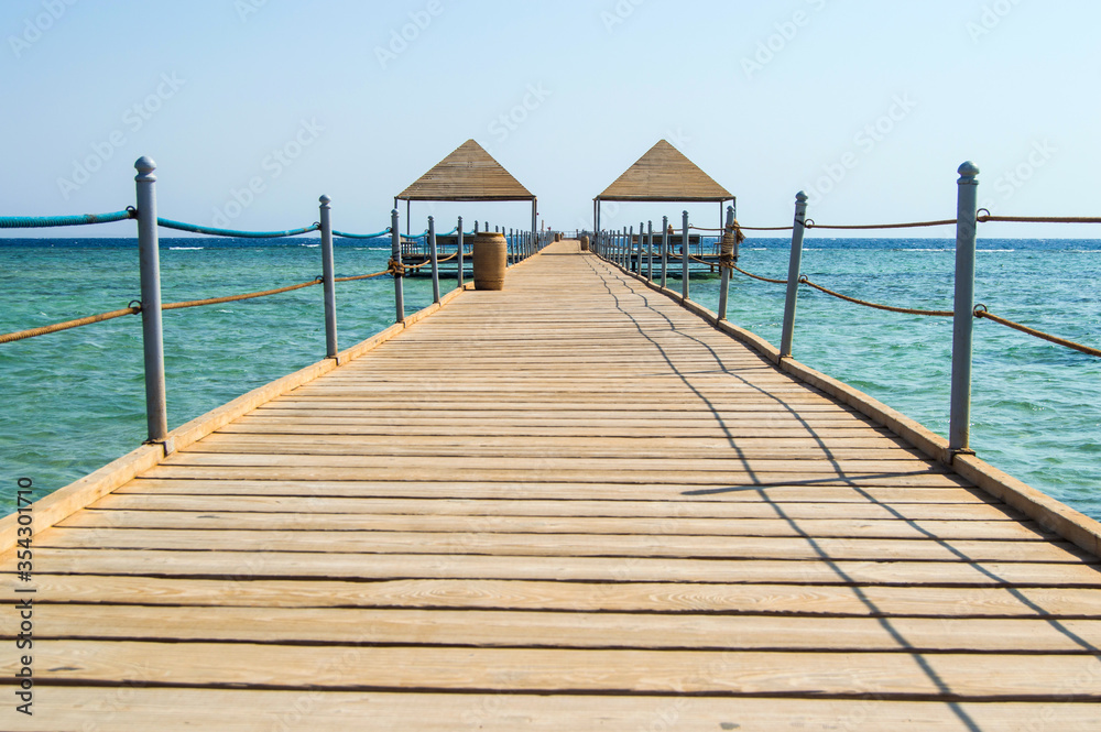 Red sea Egypt travel, relaxing seaside, turquoise sea, wooden bridge in the sea