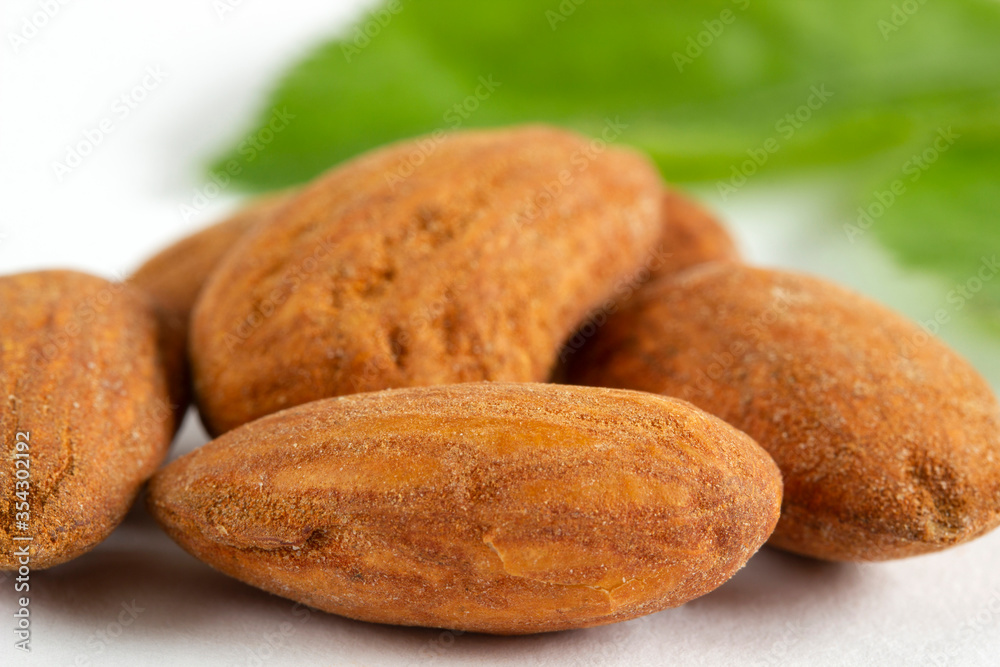A pile of Almonds, isolated on a white background. A pile of Almonds, isolated on a white background.