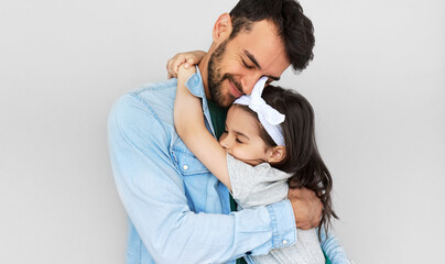 Happy father hold embrace his cute daughter. Loving daddy and his little girl cuddling and enjoying time together. Childhood and fatherhood concept.