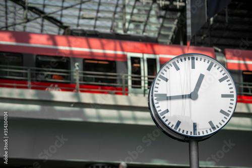 Clock on the background of a train at the railway station