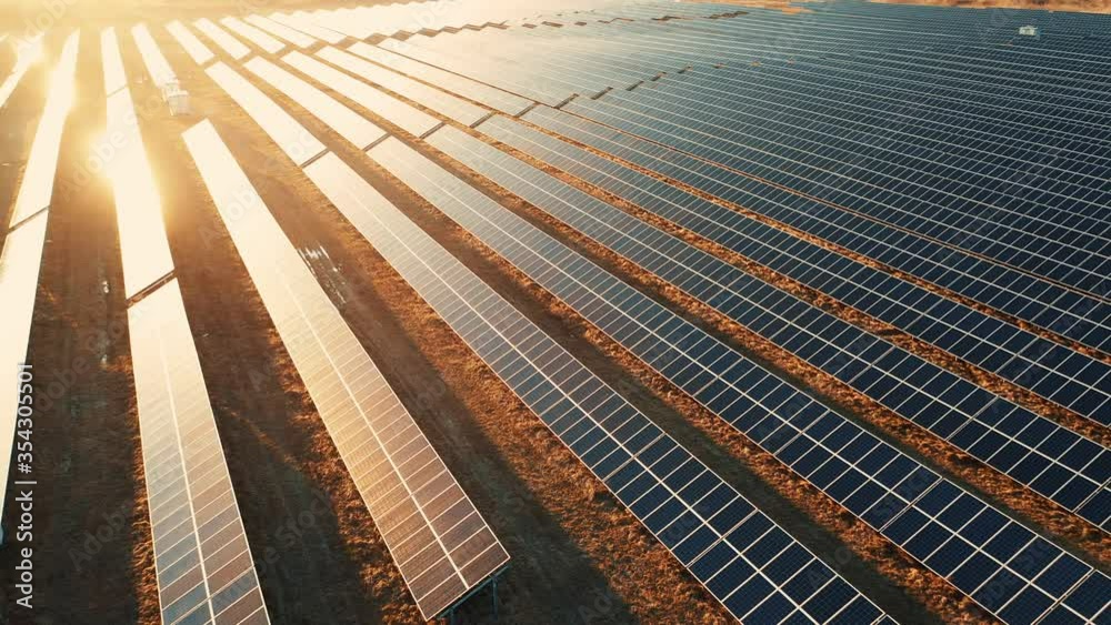 Close up solar power station panels in a row in the fields green energy at sunset landscape electrical ecology innovation nature environment slow motion