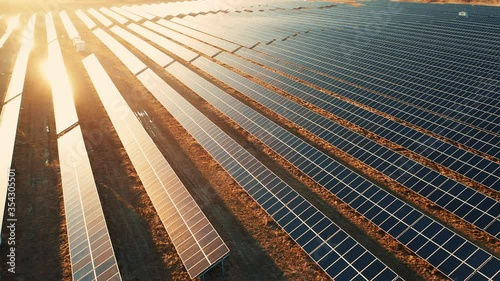 Close up solar power station panels in a row in the fields green energy at sunset landscape electrical ecology innovation nature environment slow motion