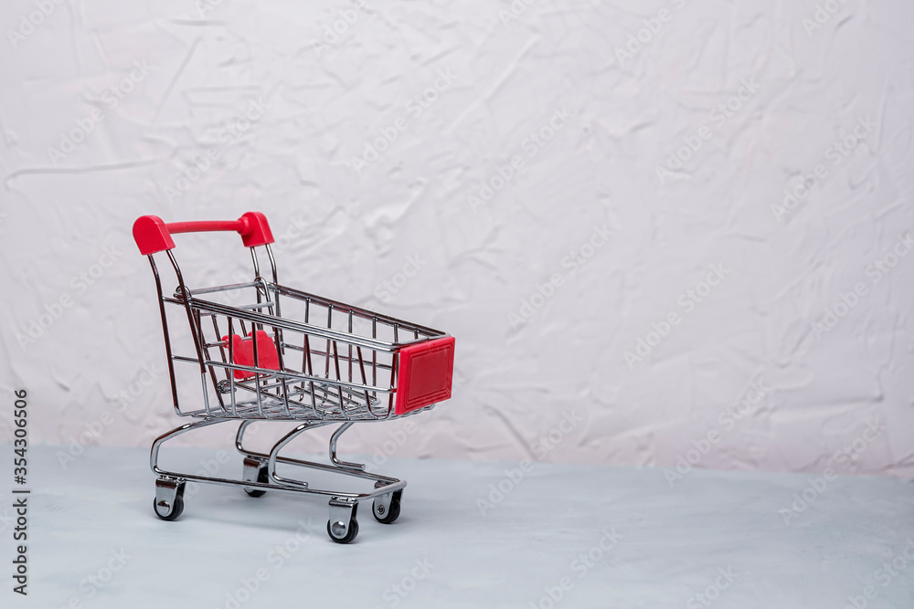 empty shopping cart on concrete background. Soft focus.