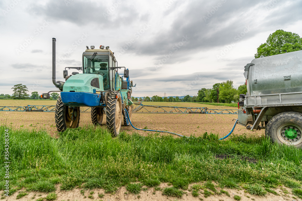 tractor adapted for spraying weeds and pests in field tractor adapted for spraying weeds and pests in field