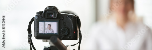 Canvas Print Close up on professional dslr camera filming new videovlog woman vlogger