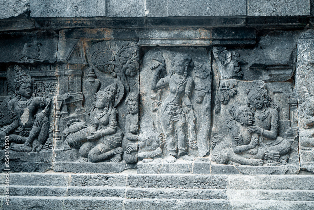 Yogyakarta Indonesia, June 4 2020 : Prambanan temple is a Hindu temple compound included in world heritage list with grass field view. Monumental ancient architecture, carved stone walls. Yogyakarta Indonesia, June 4 2020 : Prambanan temple is a Hindu temple compound included in world heritage list with grass field view. Monumental ancient architecture, carved stone walls.