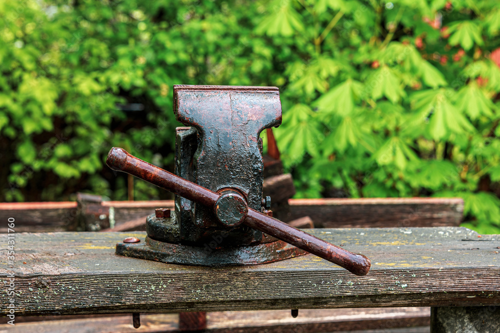 Old vise grips on a wooden bench in the backyard Old vise grips on a wooden bench in the backyard