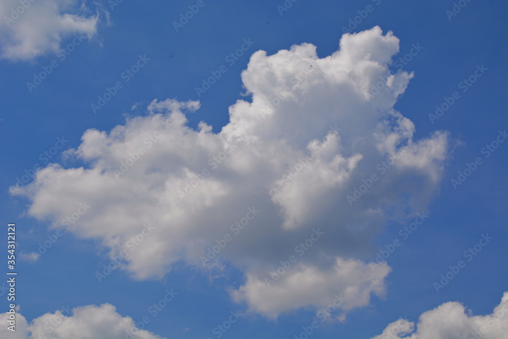 fluffy cloud in the shape of a heart on a blue sky in sunny weather fluffy cloud in the shape of a heart on a blue sky in sunny weather