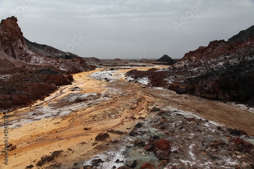 Brown rocky pathway with rhyolite red little hills on both sides photo