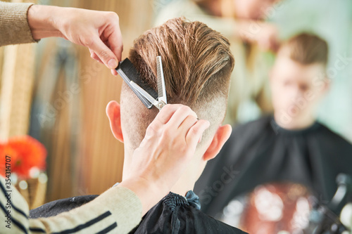 Haircut of young man. Hairdressing at barber shop
