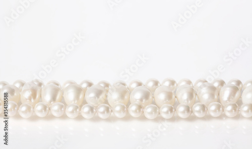 Pearl necklace on white background.