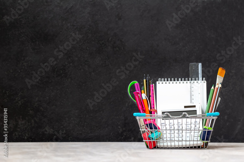 school supplies in a mini shopping basket