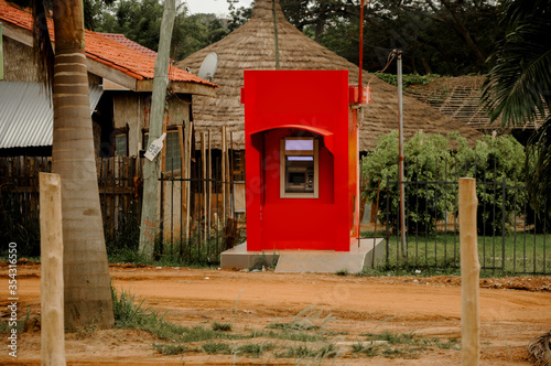 An ATM in a poor Ghanaian village - (controversial picture shows the social differences between poor and rich people) Accra, Ghana