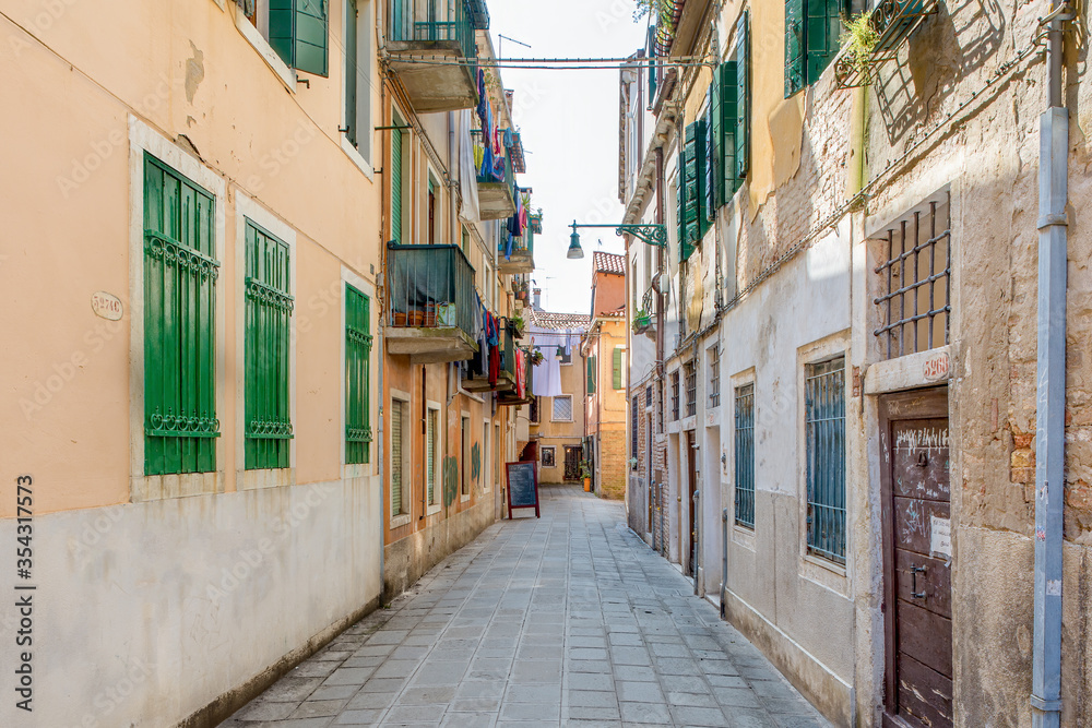 An alley between apartment buildings in the city of venice