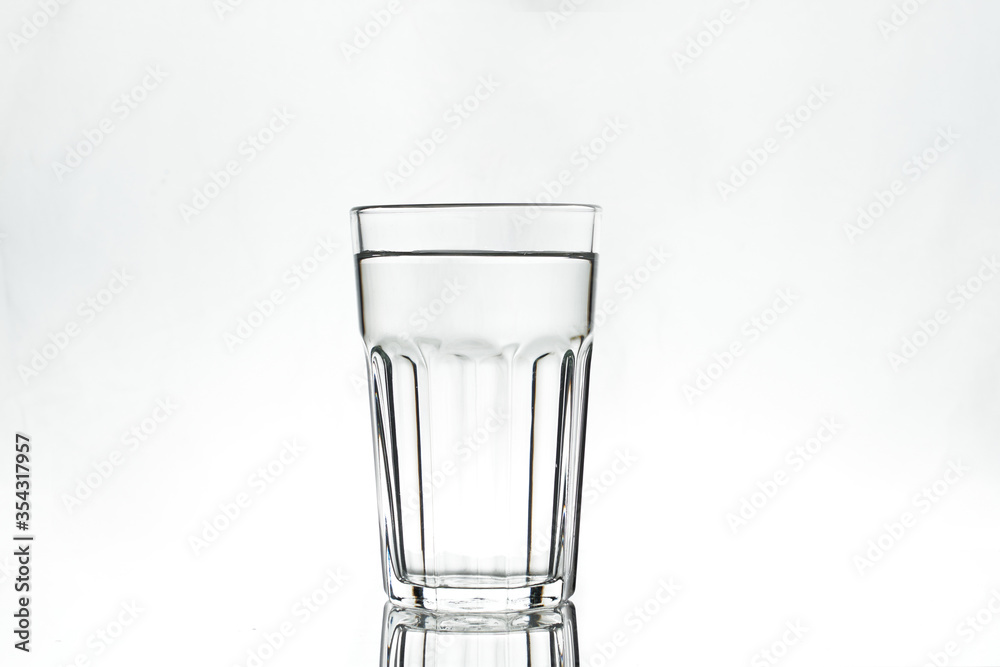 Full glass on white background. Isolated. Backlight. Full glass on white background. Isolated. Backlight.