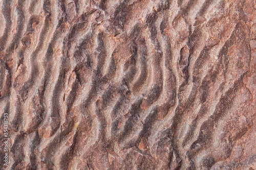 Natural rock texture backdrop. Closeup stone surface background. Abstract rough brown pattern.