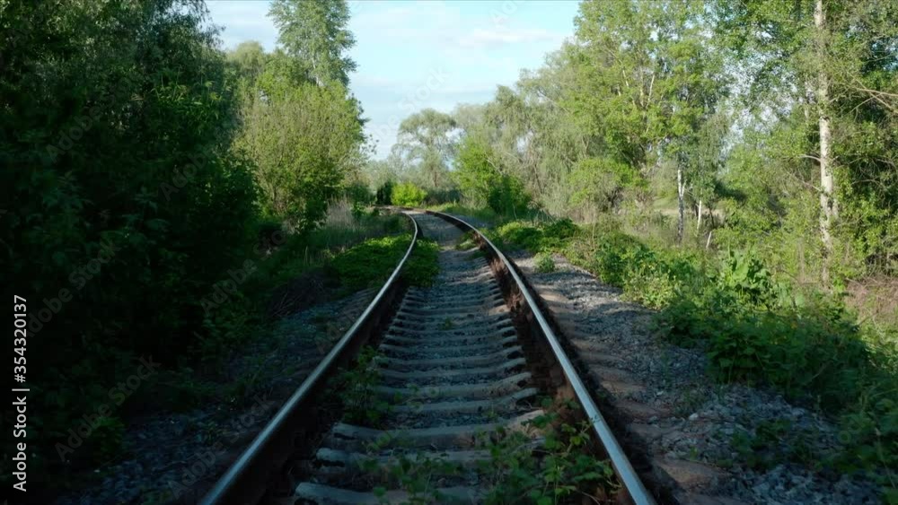 Railroad tracks. Aerial view. Railway among green trees and grass in a wooded area. Transport and travel Railroad tracks. Aerial view. Railway among green trees and grass in a wooded area. Transport and travel