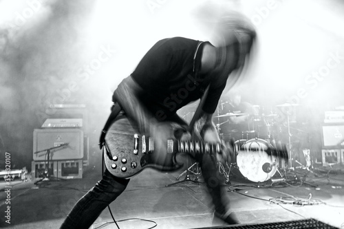 Wild rock guitarist playing on stage