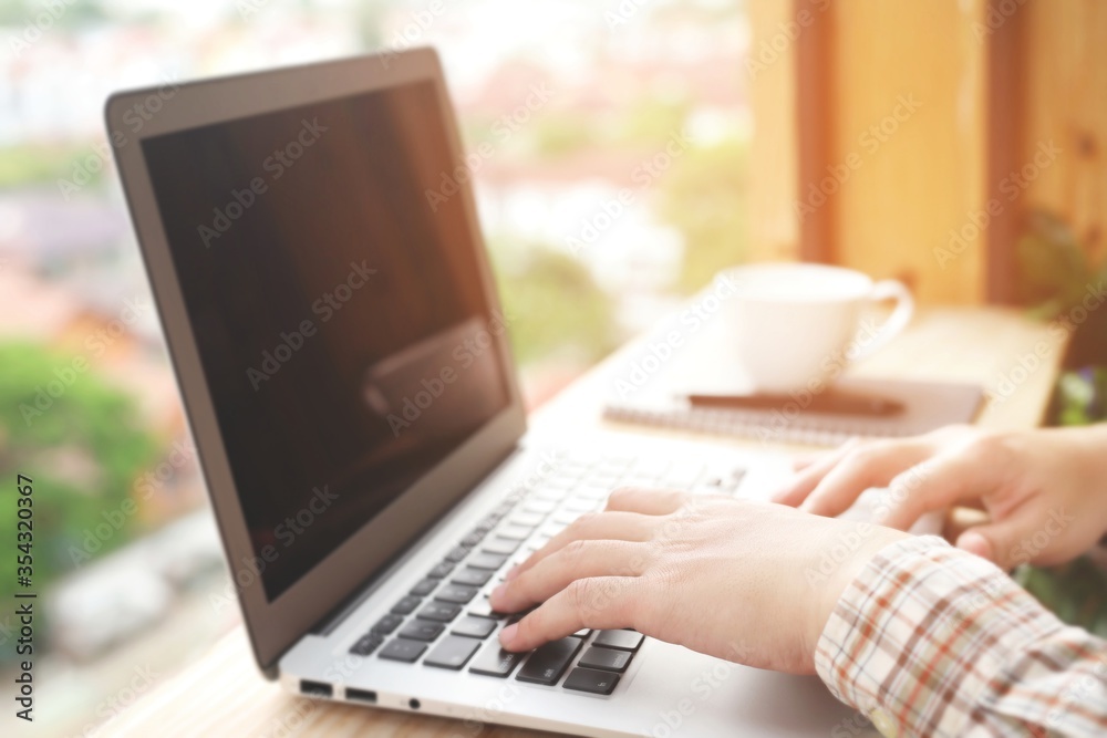 Concept work from home.man working on laptop and coffee cup. Concept work from home.man working on laptop and coffee cup.