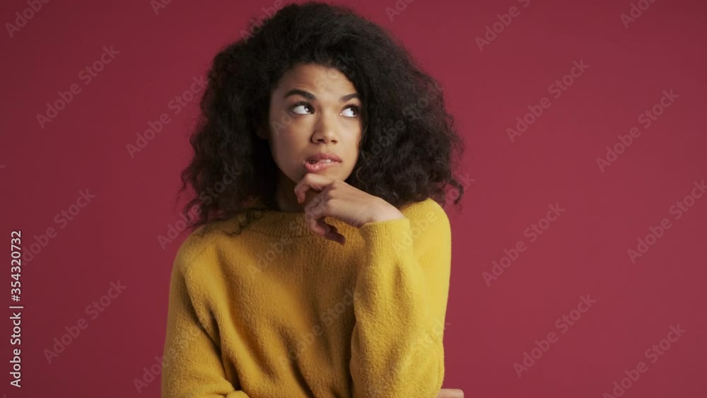Young optimistic african woman isolated over dark red burgundy background have an idea Young optimistic african woman isolated over dark red burgundy background have an idea