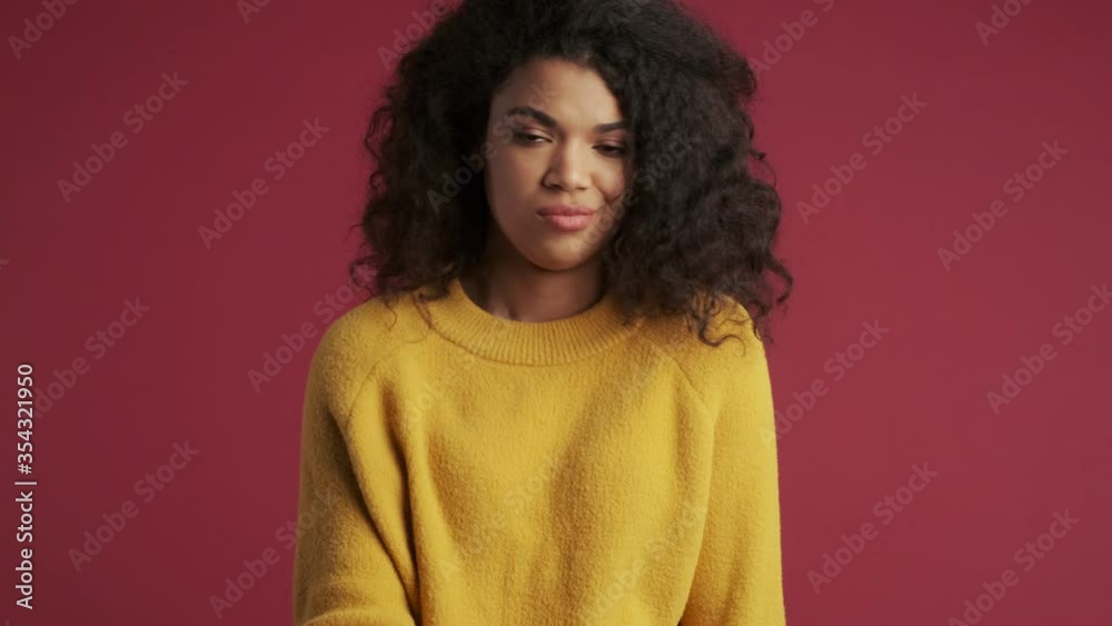 Young displeased african woman isolated over dark red burgundy background showing no gesture Young displeased african woman isolated over dark red burgundy background showing no gesture
