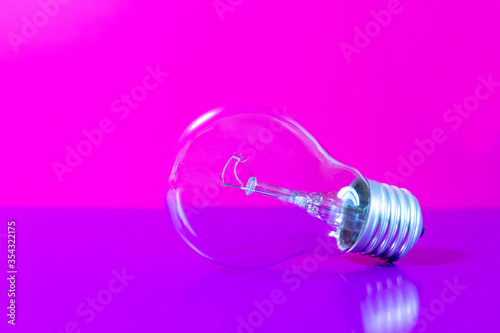 Light bulb on pink-violet background, bright ideas