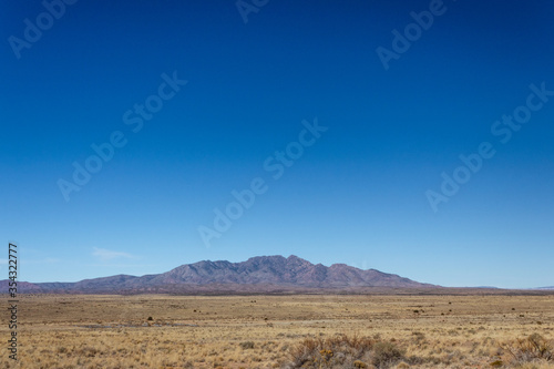 View of distant mountains across high desert plain in New Mexico USA, horizontal aspect