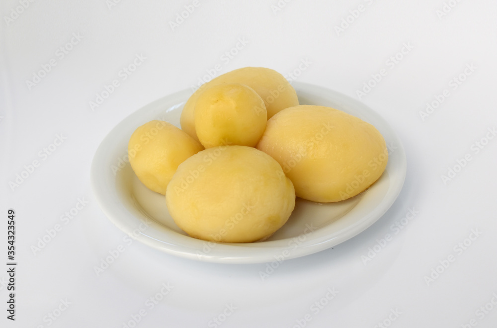 Boiled peeled potatoes on white