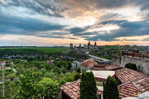 View from afar of a Kamianets-Podilskyi Castle at sunset with clouds. Horizontal orientation. 