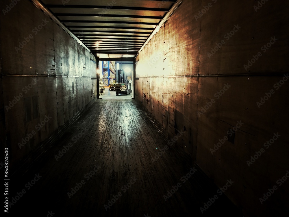 View from inside an empty semi-trailer looking out.