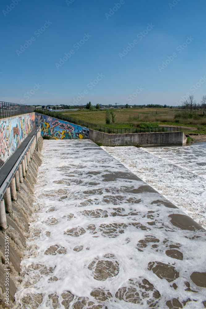 Fototapeta premium Articial water falls of Kruibeke, Antwerp, Belgium. Flood control if the tidal input of the river Scheldt cause risk the the communities