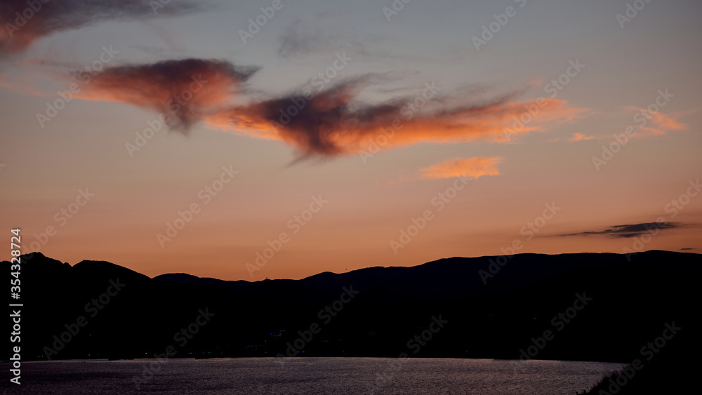Beautiful peach clouds over the sea and mountain