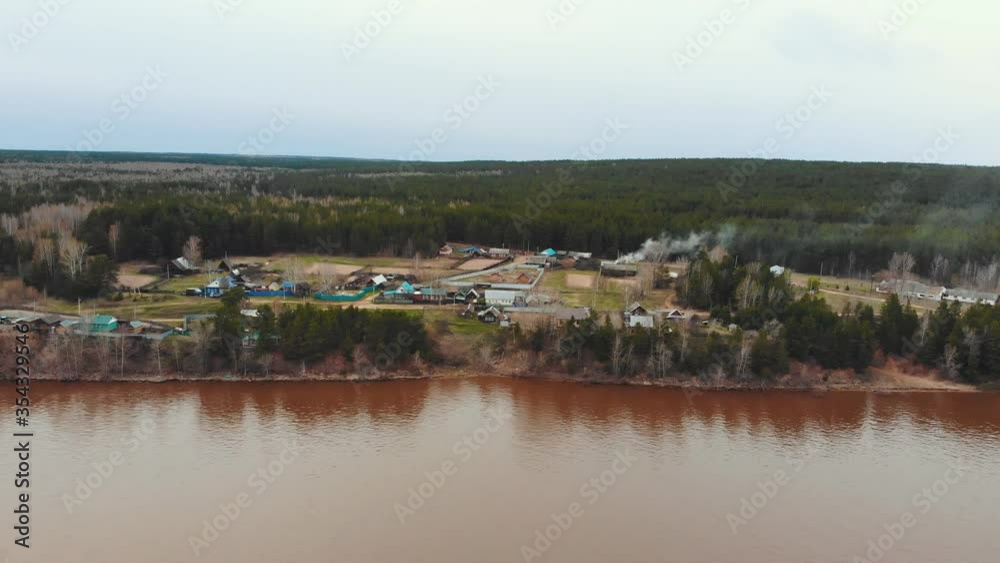 Industrial village on the coast of brown dirty river Industrial village on the coast of brown dirty river