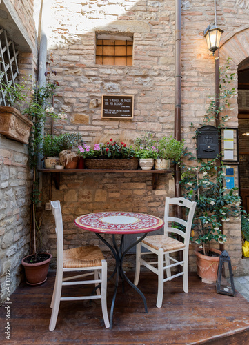 street furniture, romantic corner, chairs with table and lamp in a old italian city,street furniture for a party, photo from bottom, natural light