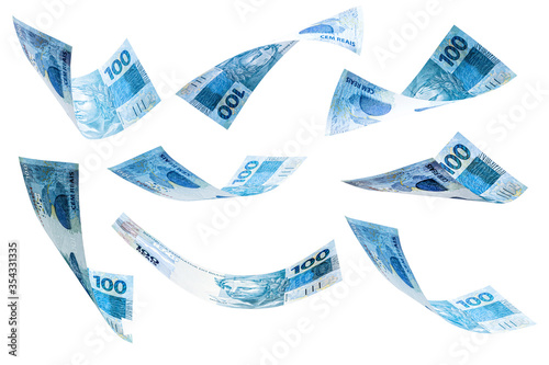 banknotes of 100 reais of brazil falling on isolated white background. Grand prize, lottery or wealth concept. photo