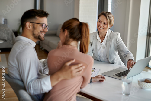 Rear estate agent having meeting with a couple in the office. photo
