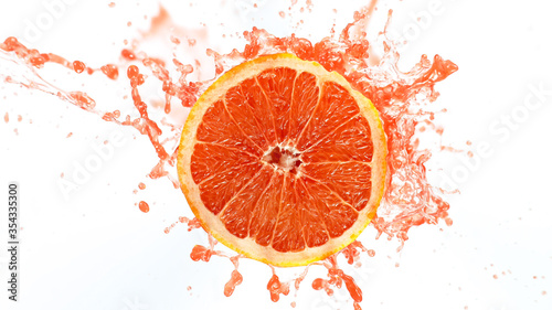 Fototapeta Naklejka Na Ścianę i Meble -  Grapefruit Slice with Splashing Juice Isolated on White Background.
