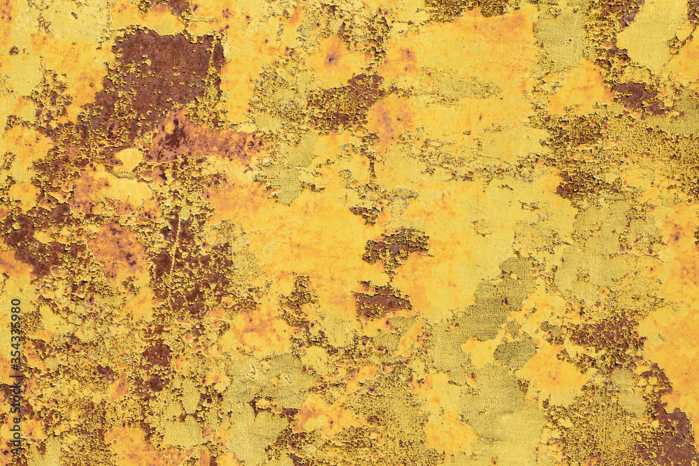Multicolored background. Rusty metal surface with yellow and brown paint flaking and cracking texture Multicolored background. Rusty metal surface with yellow and brown paint flaking and cracking texture