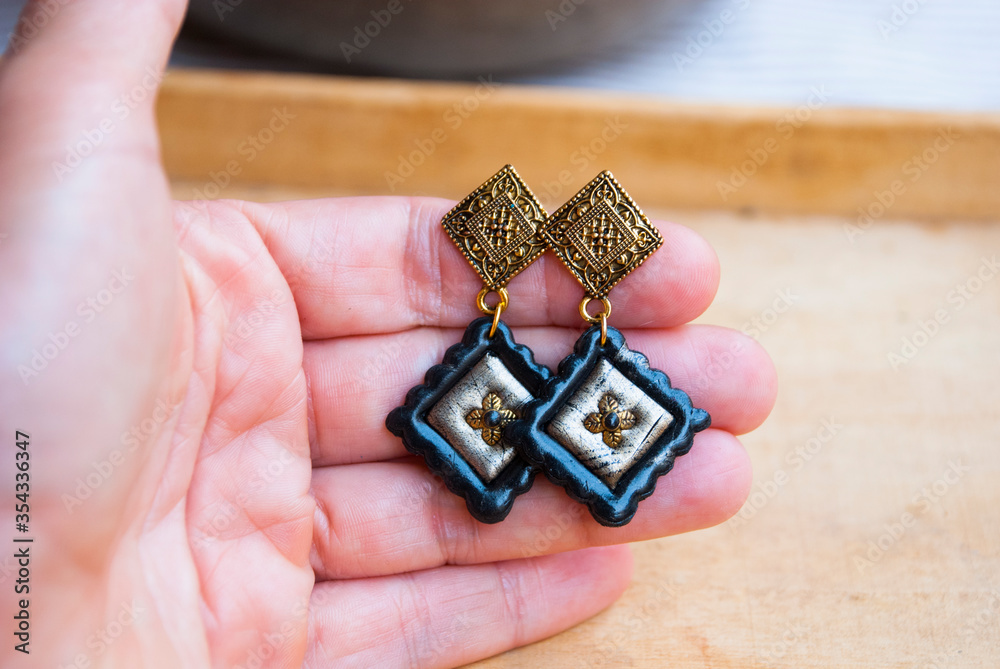 Fototapeta premium Gold Black bohemian earrings. Handmade jewelry design.