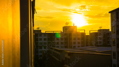 Silhouette condominium building sunset yellow sky with cloud