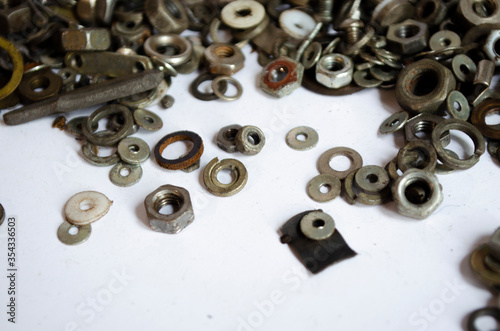 nuts for bolts on a white background © Евгения Соломенная